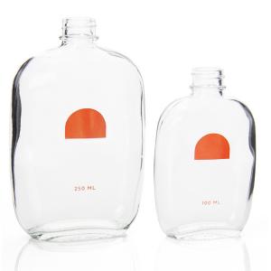 China Custom 50ml 200ml Small Glass Juice Bottles Flat With Screw Lid on sale